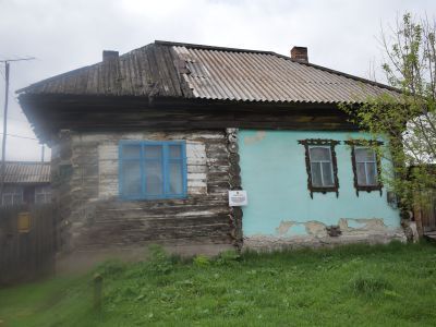 Деревянный жилой дом конца XIX века начала XX века с обильной пропильной резьбой по карнизам и наличниками